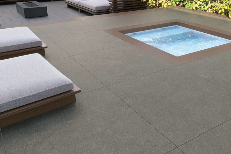 Surface patio setting using grey bush hammered tile